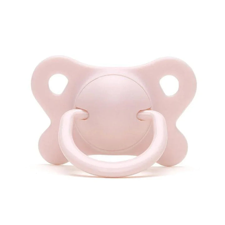 Soft pink baby pacifier with butterfly-shaped shield on white background