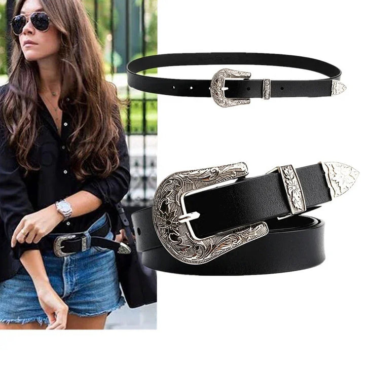 Black leather belt with engraved silver buckle, loop, and tip, styled on woman with black shirt and denim skirt