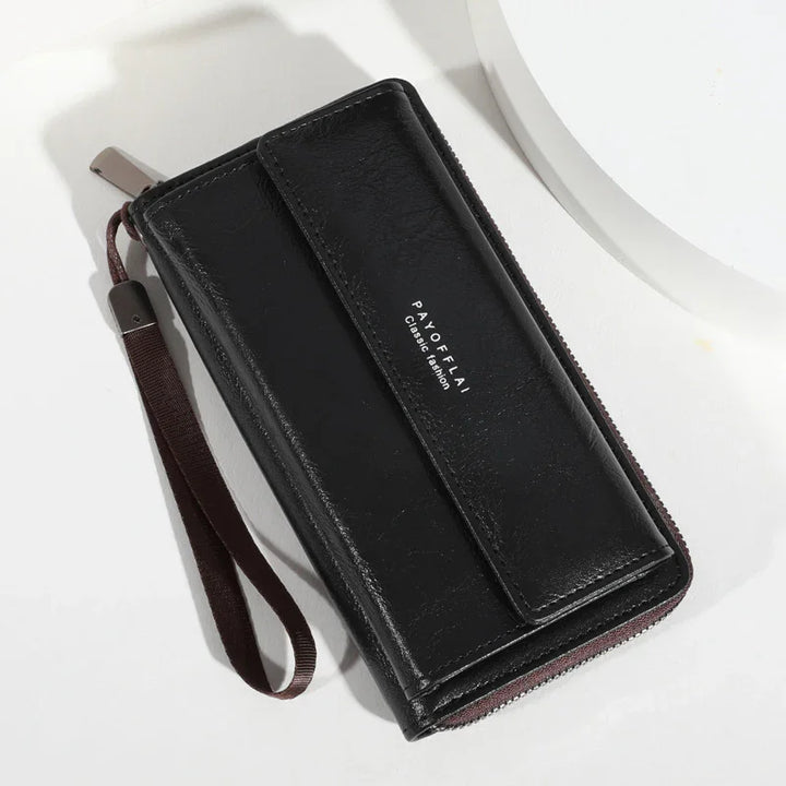 black leather zipper wallet with wrist strap and flap closure on white background