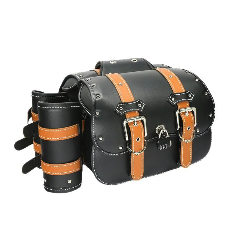 Black leather motorcycle saddlebag with brown straps and metal studs on white background