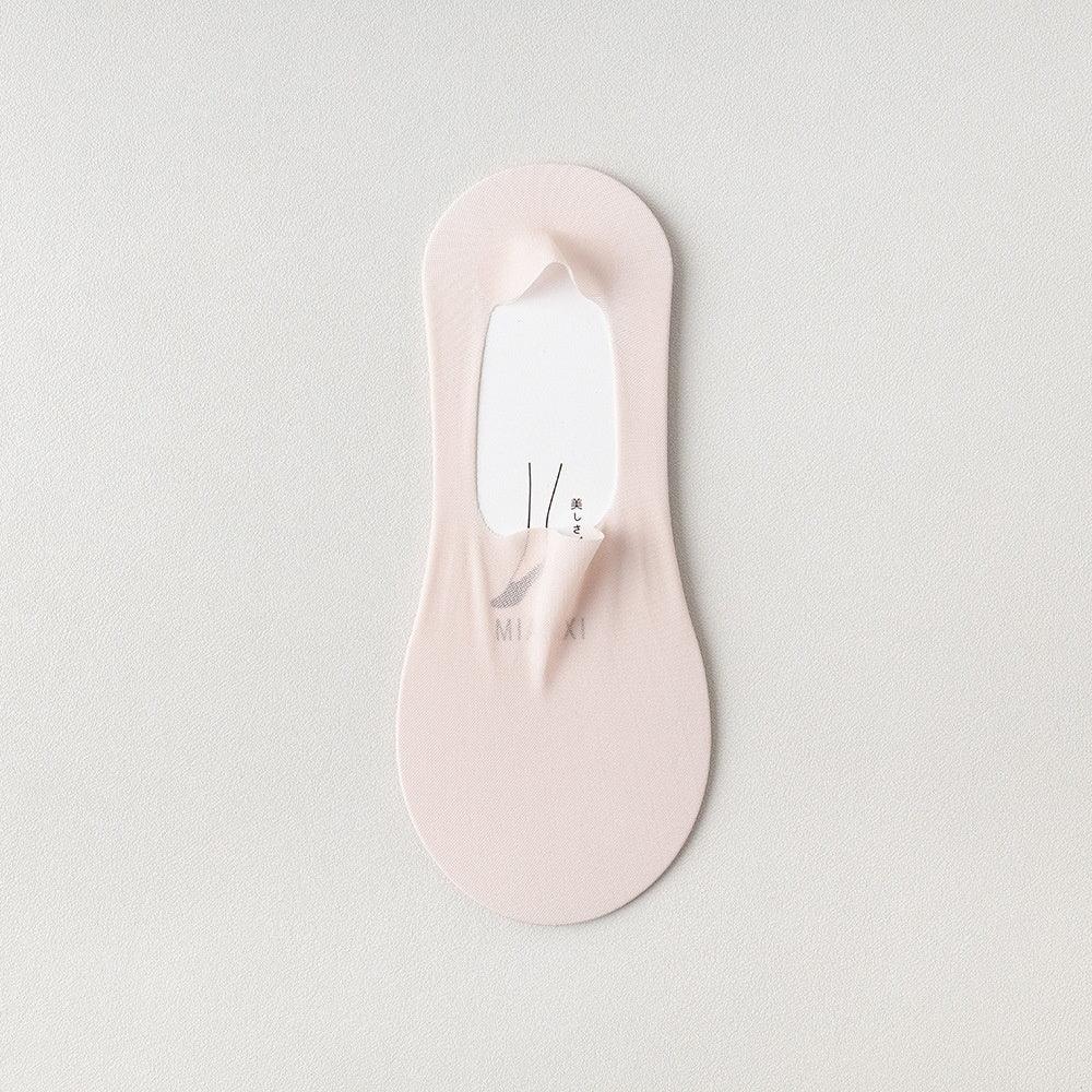 Light pink no-show sock with a textured surface on a white background