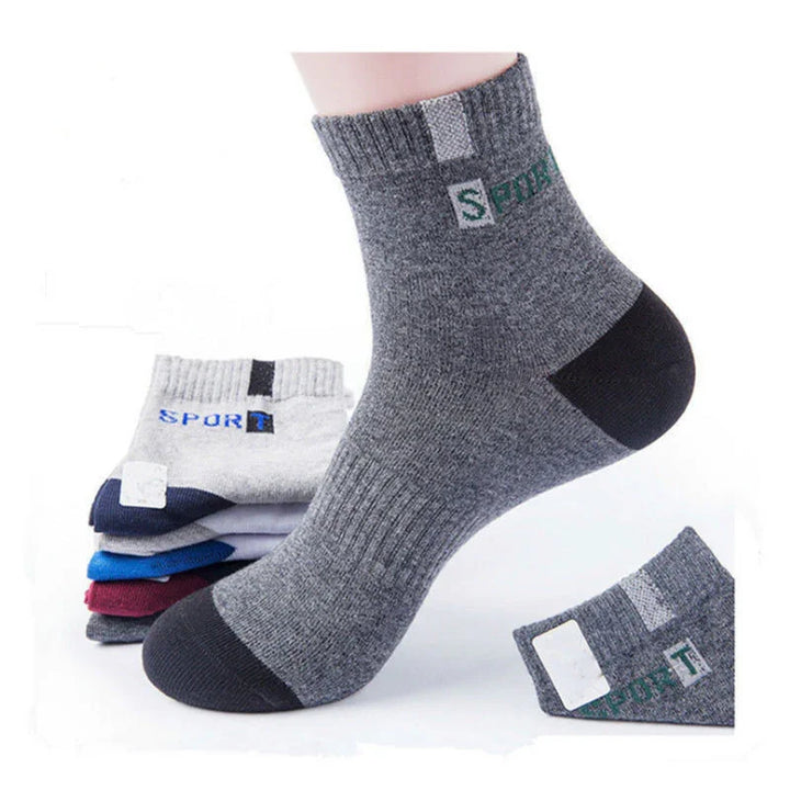 Gray ankle sports sock with black toe and heel, showing textured knit and green SPORT logo