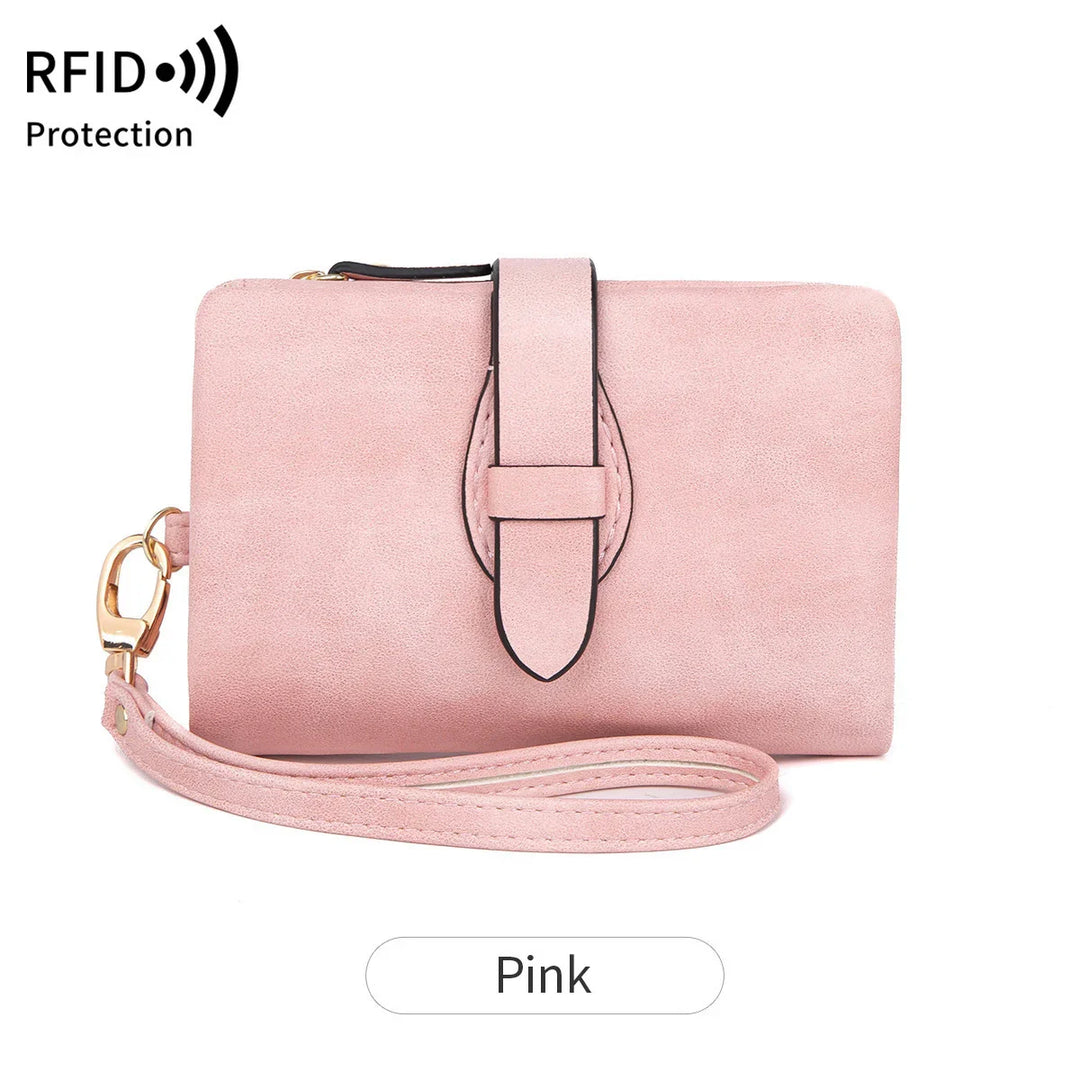 Pink RFID protection wallet with wrist strap and buckle detail on white background