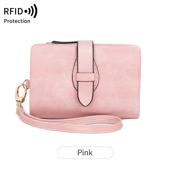 Pink RFID protection wallet with wrist strap and buckle detail on white background