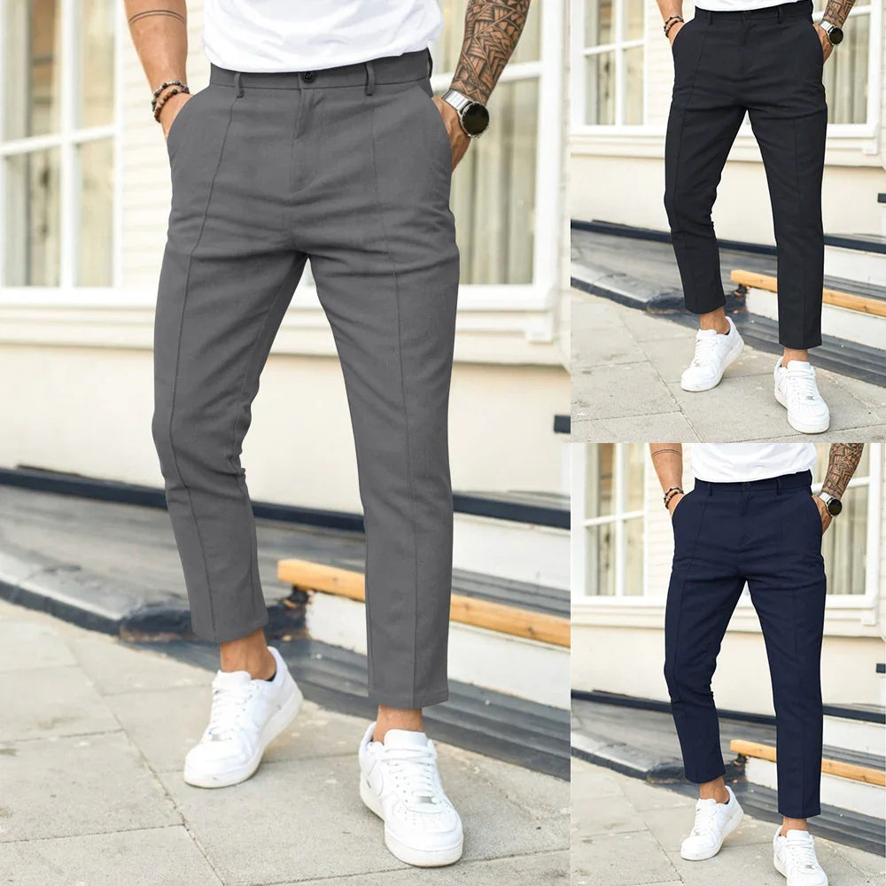 Men's slim fit cropped trousers in gray, black, and navy paired with white sneakers outdoors