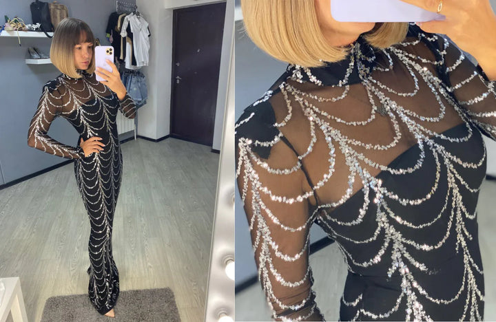 Woman taking mirror selfie wearing a black sheer long dress with silver sequin patterns in a boutique fitting room