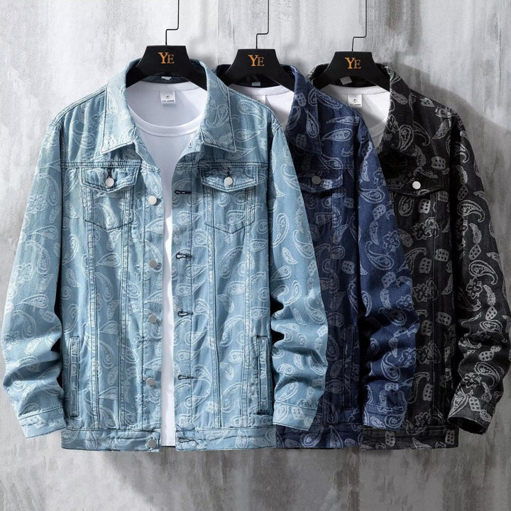 Three paisley patterned denim jackets in light blue, navy, and black on black YE hangers