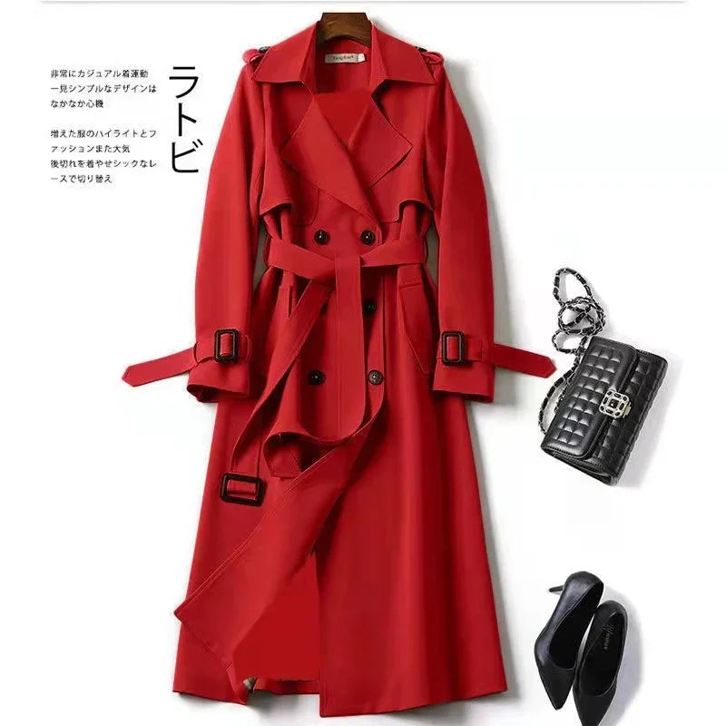 Red double-breasted trench coat with belt, black quilted handbag, and black high heels on white background