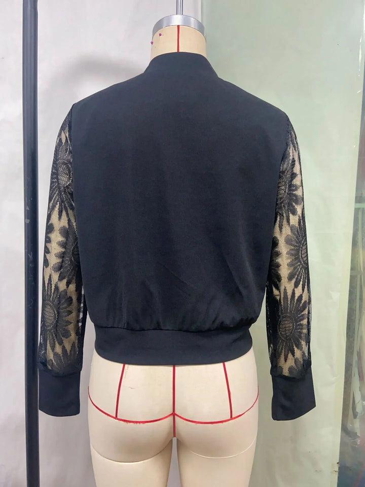 Back view of black top with mesh floral lace sleeves on dress form mannequin