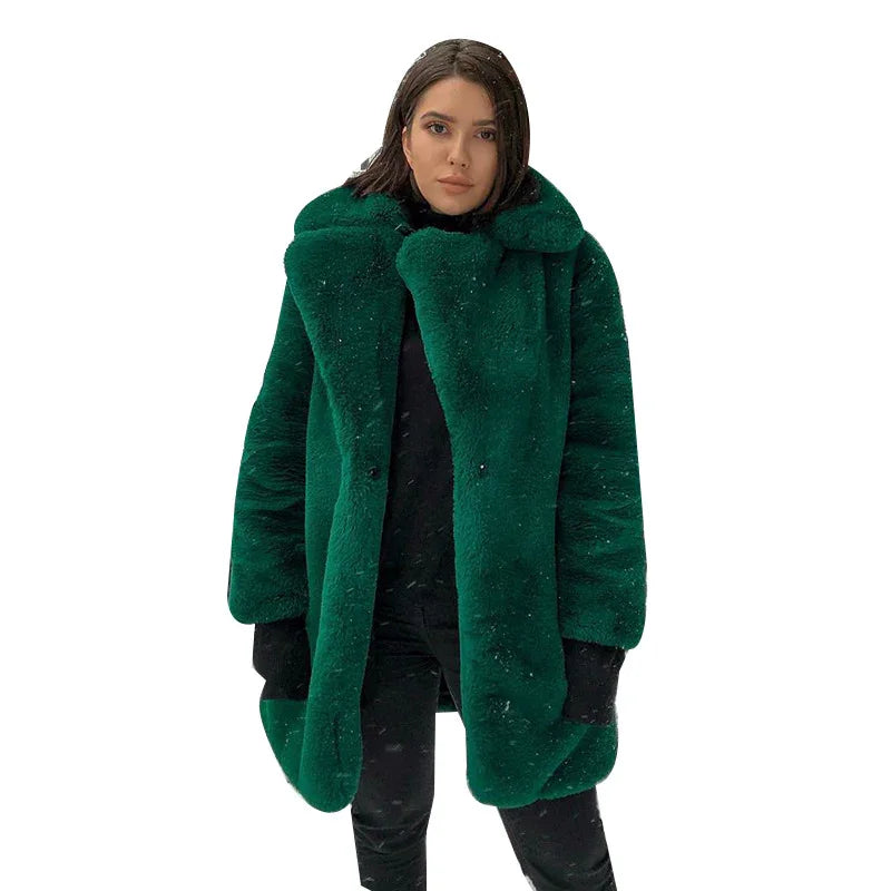 Woman wearing a luxurious green faux fur coat over black outfit on white background