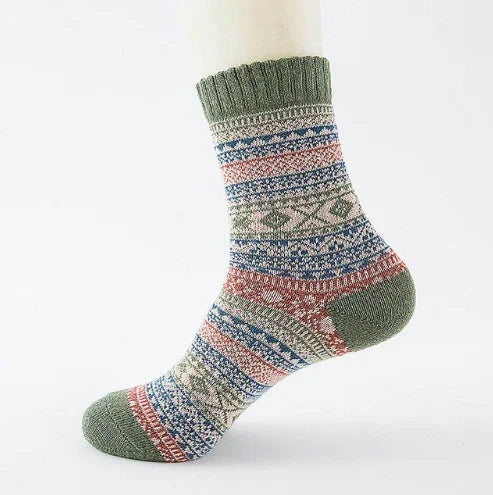 Multi-color patterned wool sock with green cuff, heel, and toe on white background