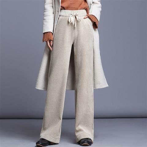 Winter outfit featuring beige ribbed wide-leg pants with drawstring and light gray long coat