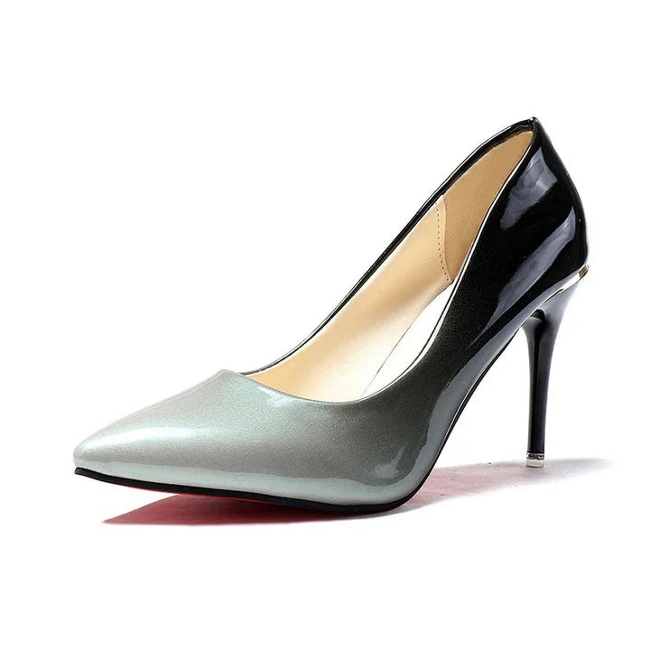 Glossy black and gray pointed-toe high heel pump with stiletto heel on white background