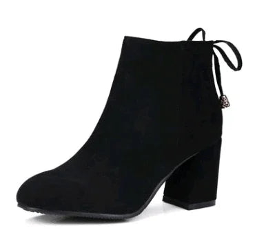 black suede ankle boot with block heel and decorative lace tie at back