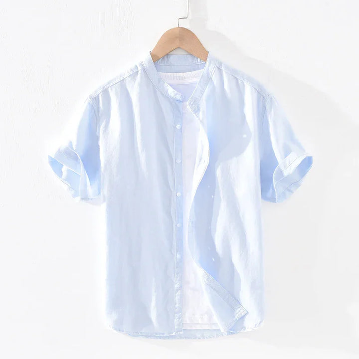 Light blue short-sleeve button-up shirt with mandarin collar on wooden hanger