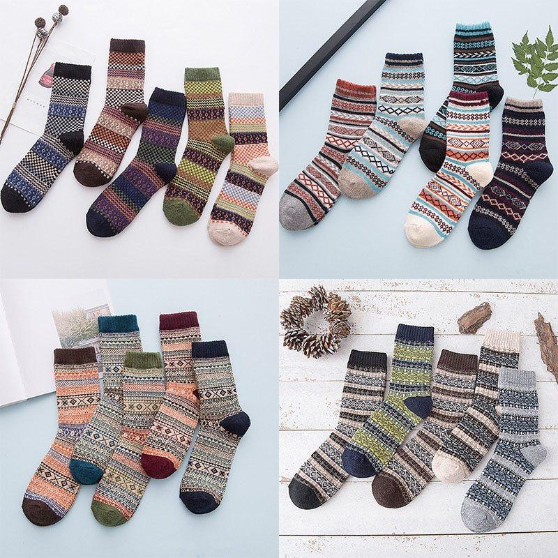 Four sets of colorful patterned wool socks displayed on white and light blue backgrounds, featuring geometric and stripe designs