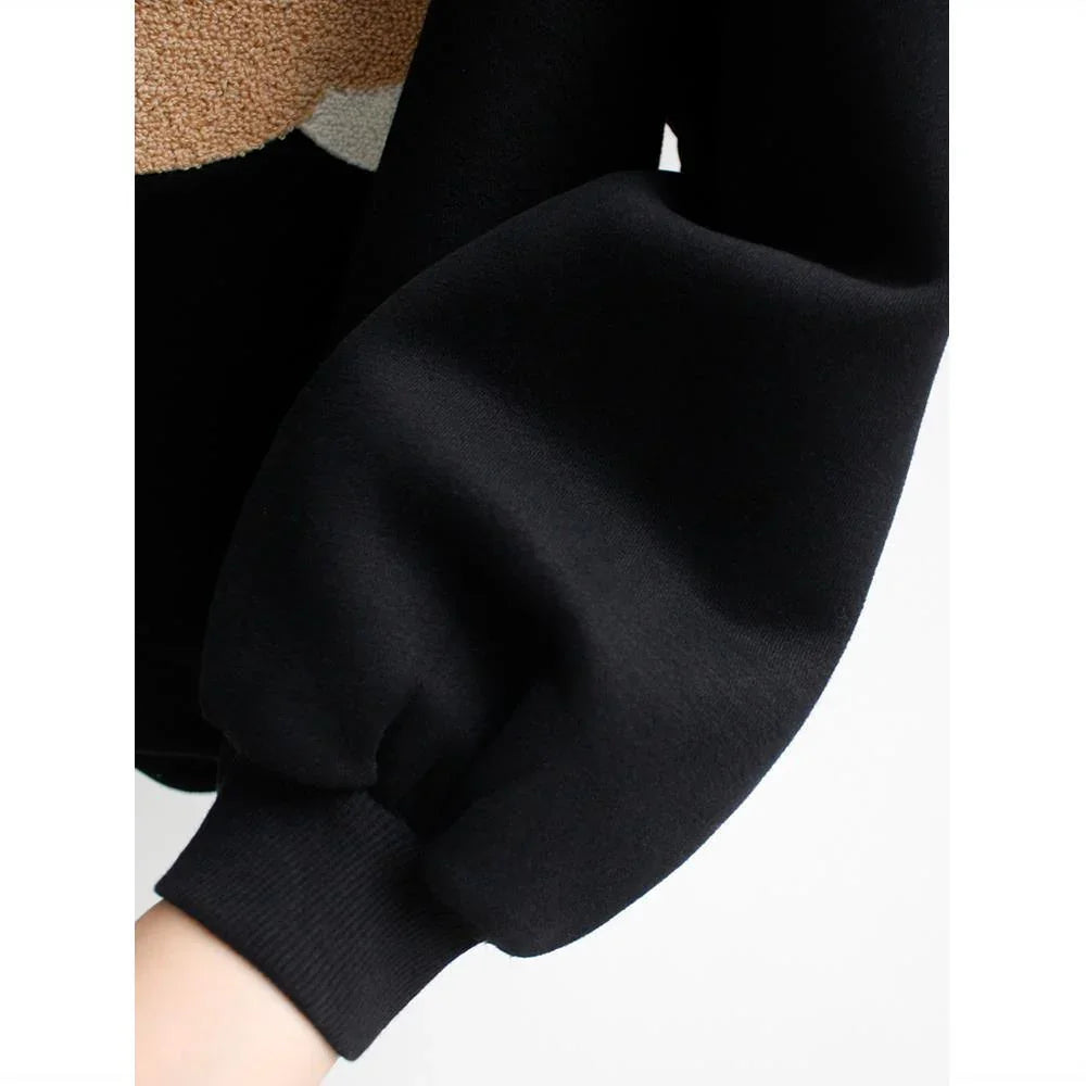 Close-up of black long sleeve cuff with ribbed wrist and soft fabric detail