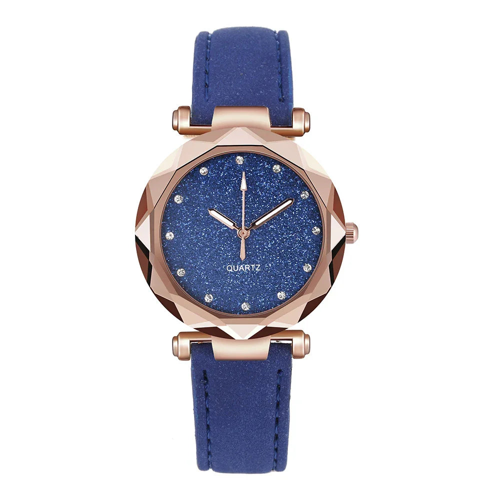 Luxury quartz wristwatch with blue glitter dial, crystal hour markers, rose gold faceted case, and blue leather strap