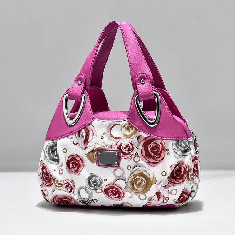 Fashionable pink and white handbag with floral rose pattern and silver metal accents
