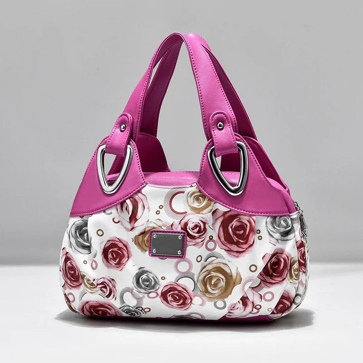 Fashionable pink and white handbag with floral rose pattern and silver metal accents