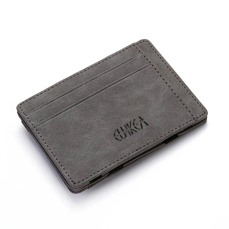 Gray leather minimalist wallet with card slots and embossed logo on white background