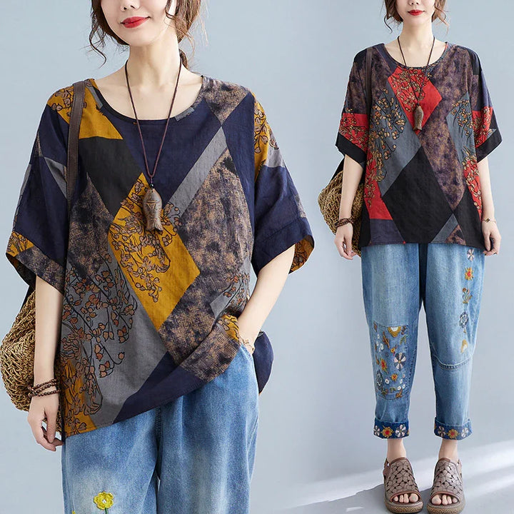 Woman wearing loose patchwork geometric print tops with floral embroidery jeans and woven handbag