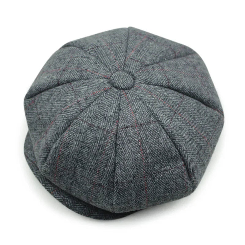Gray tweed newsboy cap with herringbone pattern and subtle red lines on white background