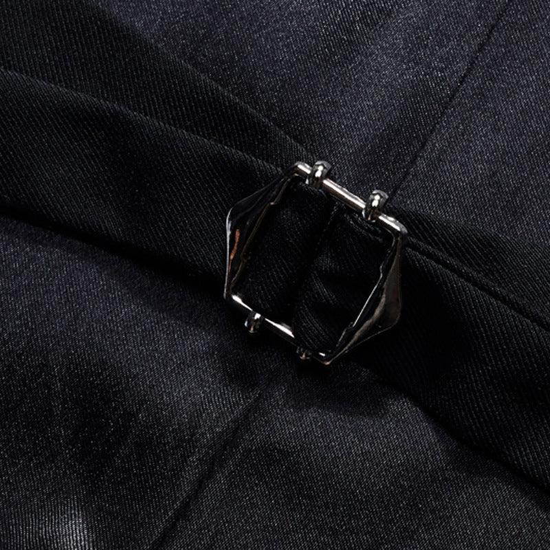 Close-up of black fabric with a silver-toned rectangular buckle detail