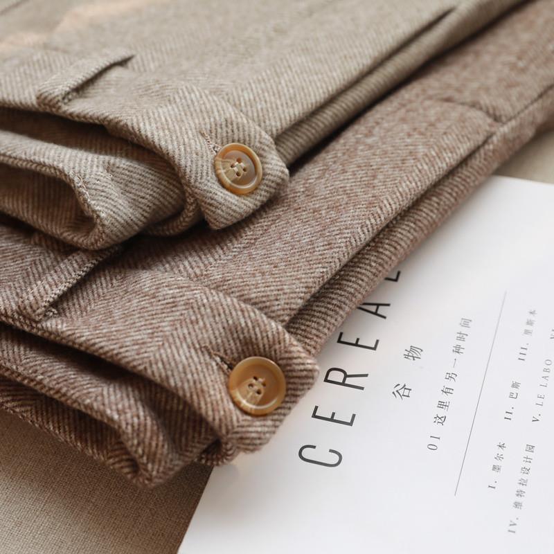 Folded brown herringbone fabric with button details on a magazine titled Cereal