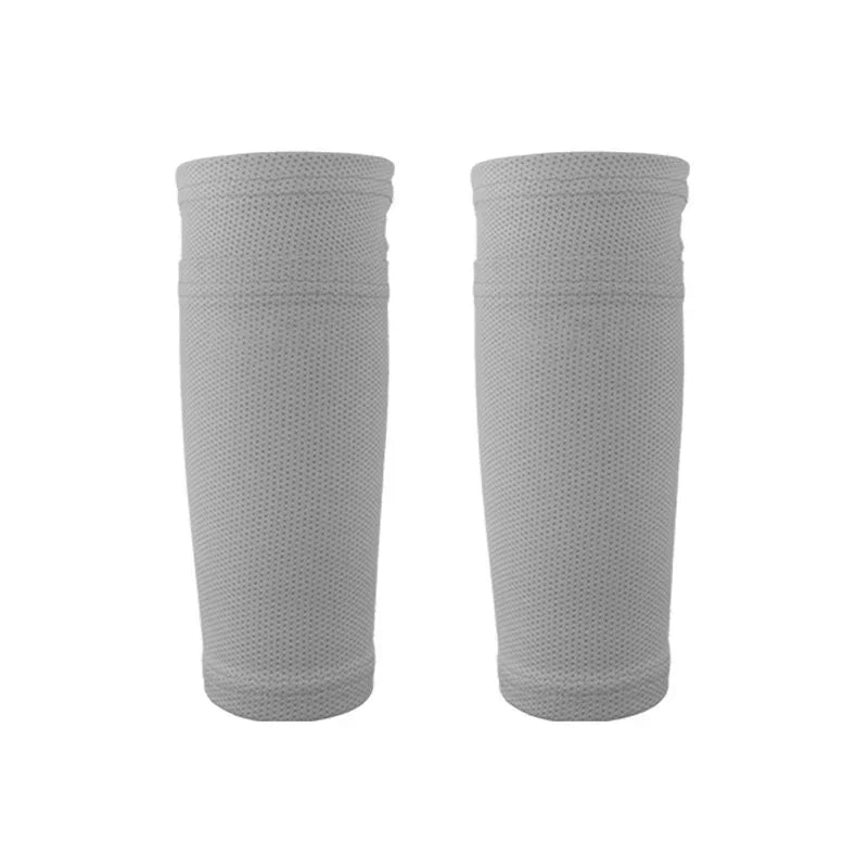 Pair of gray breathable compression leg sleeves on white background