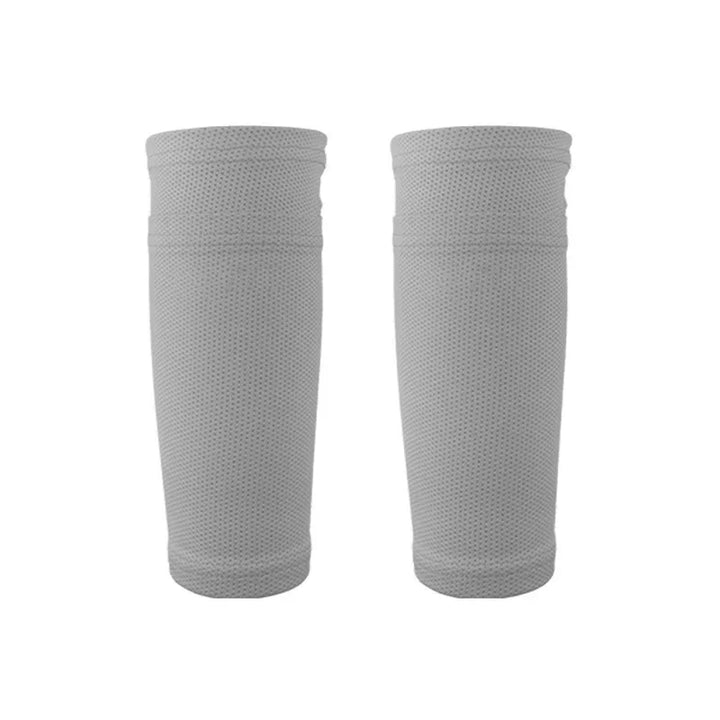 Pair of gray breathable compression leg sleeves on white background