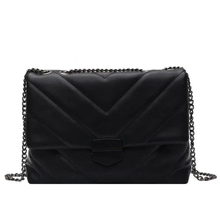 Black quilted leather crossbody bag with chevron pattern and silver chain strap