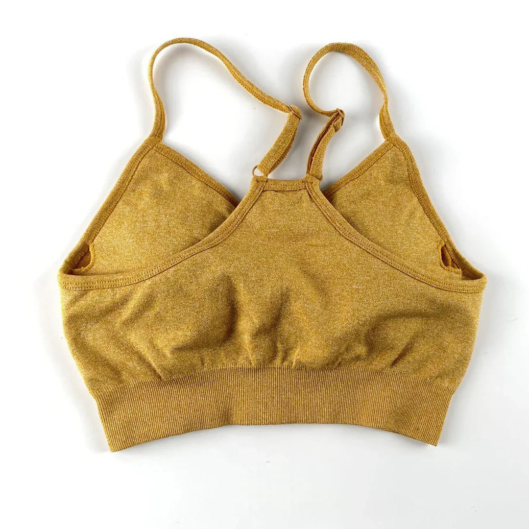 Mustard yellow knit bralette with adjustable straps on white background