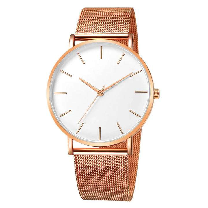 Minimalist rose gold wristwatch with white dial and mesh band on white background