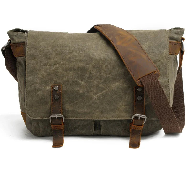 green canvas messenger bag with brown leather straps and adjustable shoulder strap