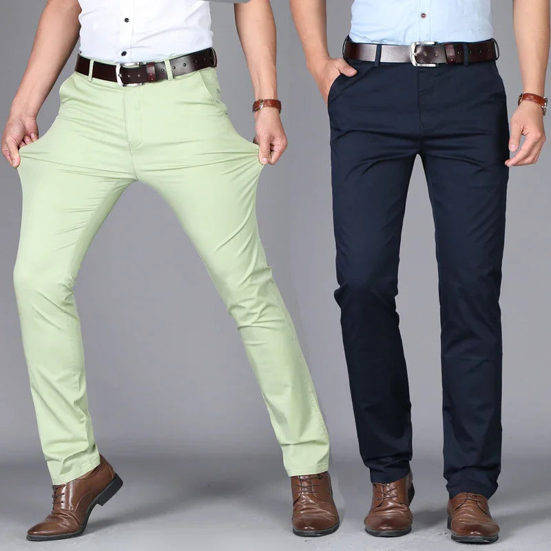 Two men wearing slim fit casual pants in light green and navy blue with brown leather belts and dress shoes