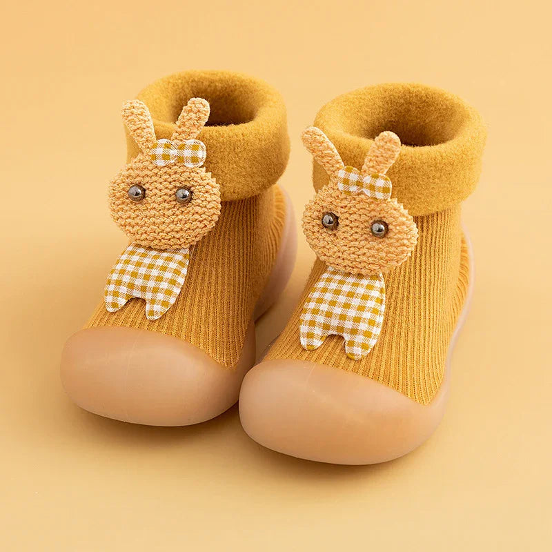 Yellow toddler shoes with rubber soles and cute knitted animal faces on front