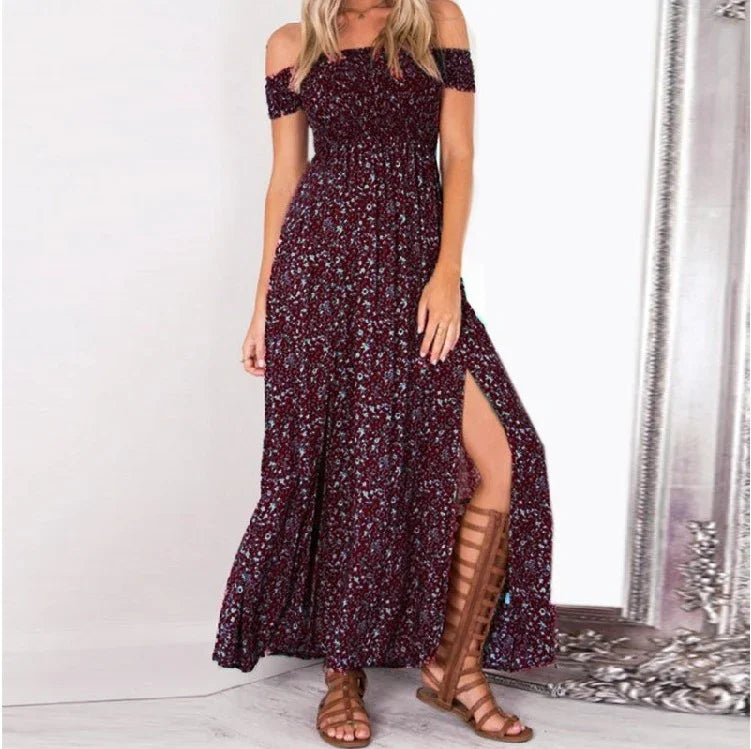 Woman wearing a maroon floral off-shoulder maxi dress with a front slit and brown gladiator sandals