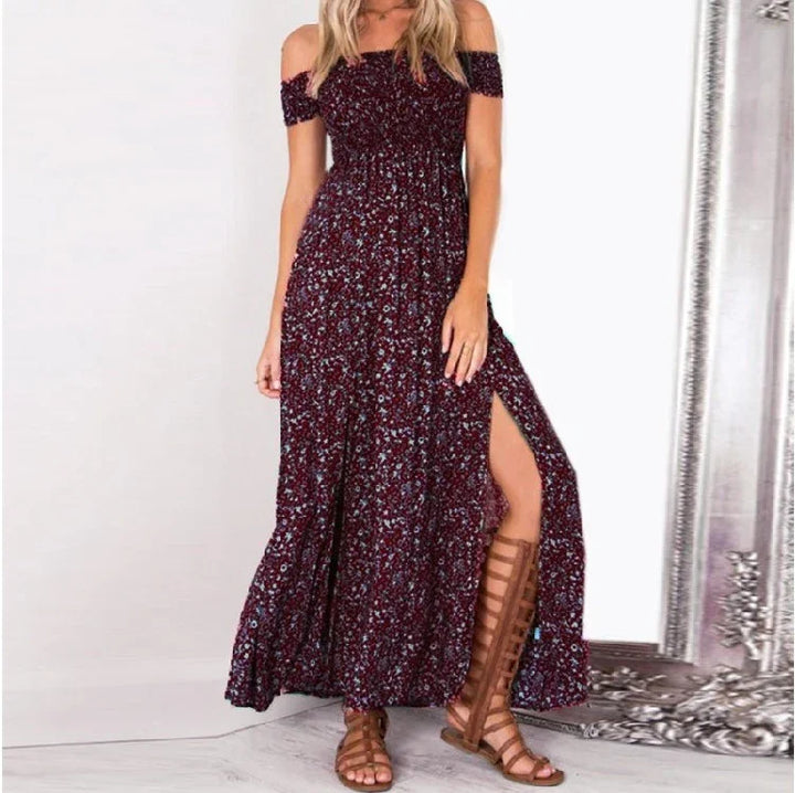 Woman wearing a maroon floral off-shoulder maxi dress with a front slit and brown gladiator sandals