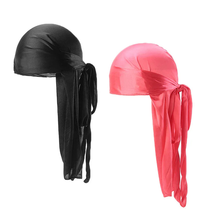 Black and pink silky durag headwraps with long tails tied at the back on white background