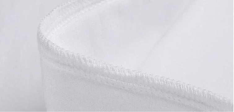 Close-up of white fabric stitching detail on curved edge, highlighting seam and texture