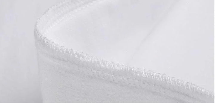 Close-up of white fabric stitching detail on curved edge, highlighting seam and texture