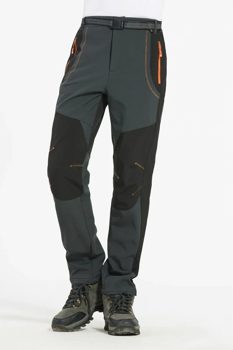 Men's black and gray outdoor hiking pants with orange zipper pockets and reinforced knees
