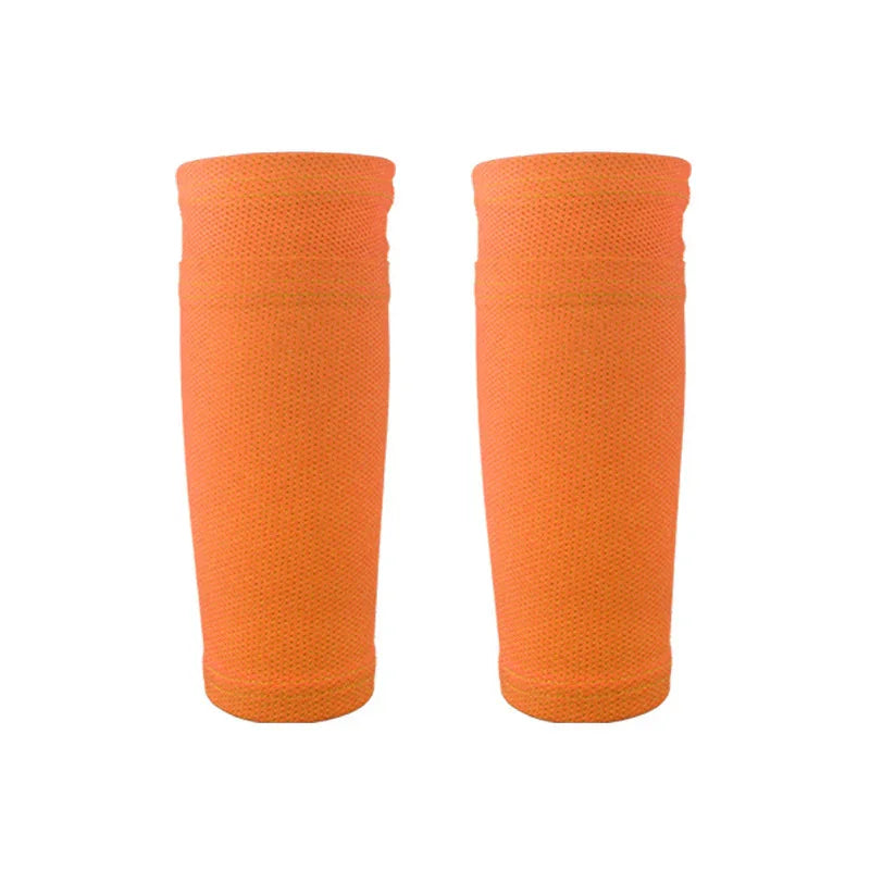 Pair of orange compression arm sleeves with textured fabric on white background