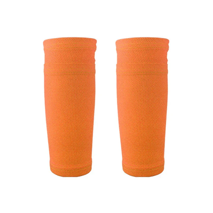 Pair of orange compression arm sleeves with textured fabric on white background