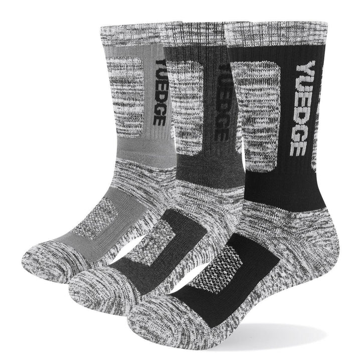 Three pairs of cushioned crew socks in gray, charcoal, and black with YUEDGE branding and padded soles