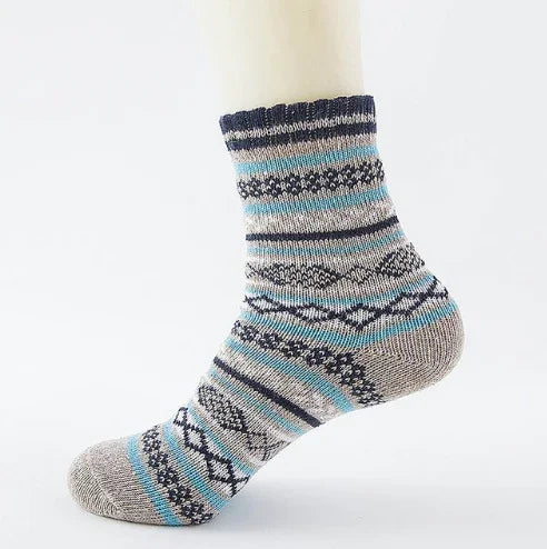 Grey wool sock with blue and black geometric patterns on a white background