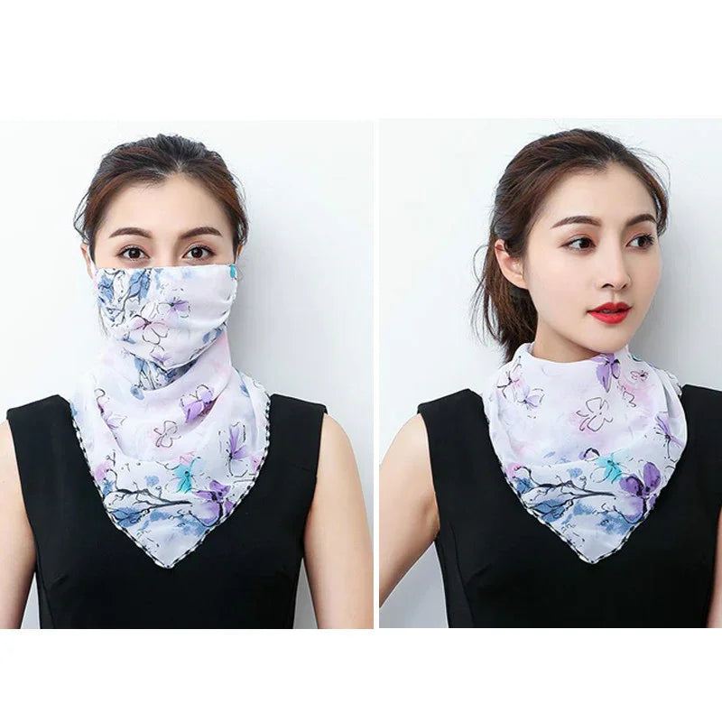 Woman wearing floral print neck gaiter styled as face mask and scarf with black sleeveless top