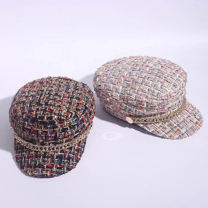 Two stylish tweed newsboy caps with gold chain accents, one in dark multicolor and one in light multicolor fabric