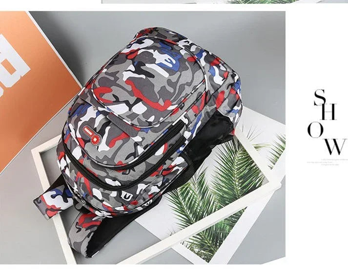 Multicolor camouflage print sling backpack with zippers on gray background and palm leaf decor